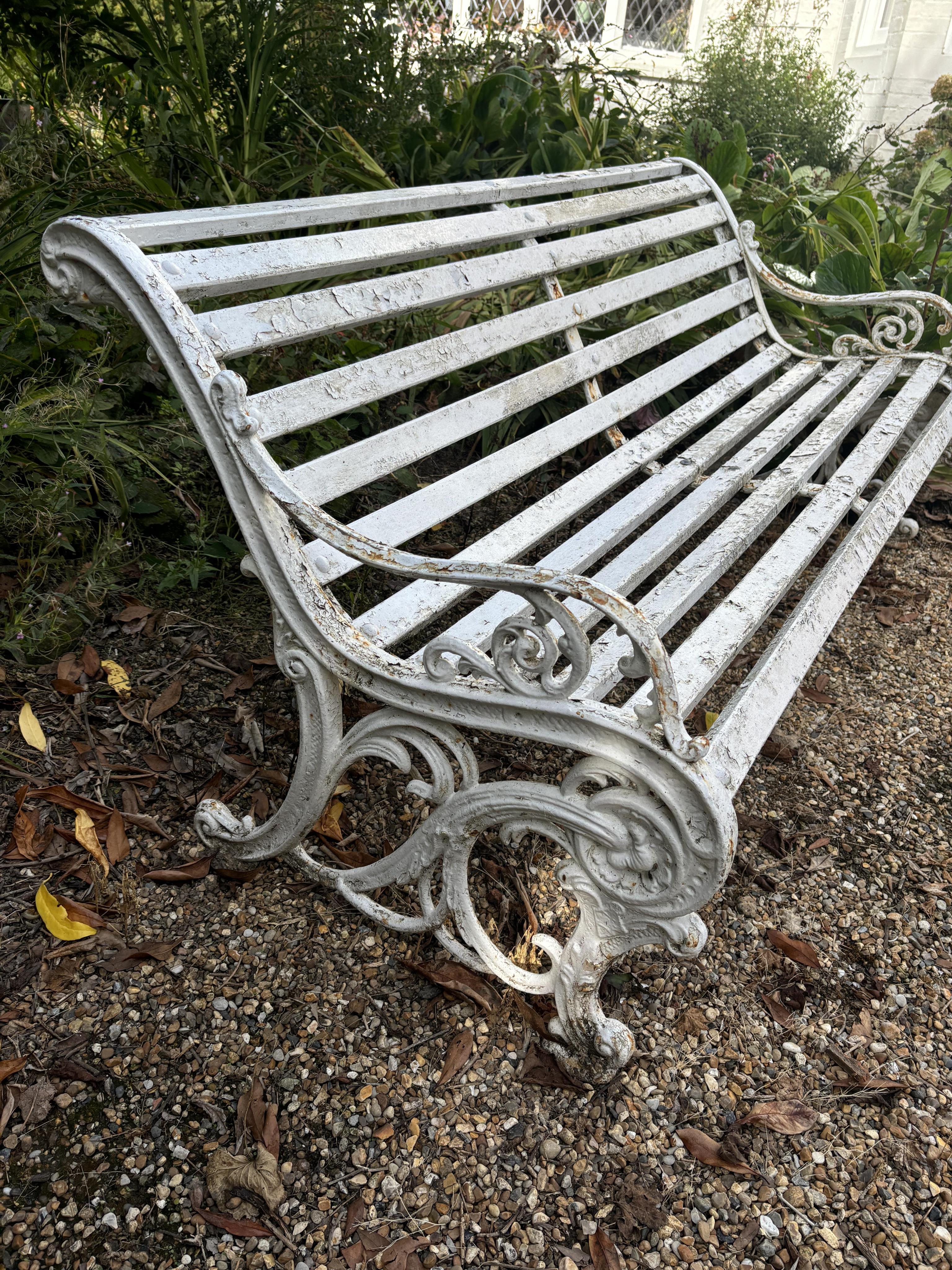 A white painted wrought iron and wood slatted garden bench, 163cm. Condition - weathered, otherwise solid